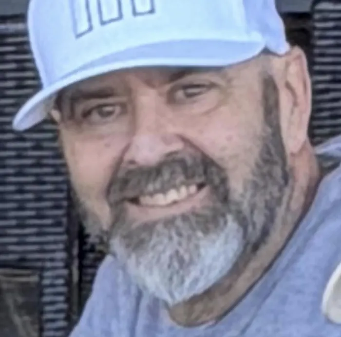 Dave Brennan smiling in a cap